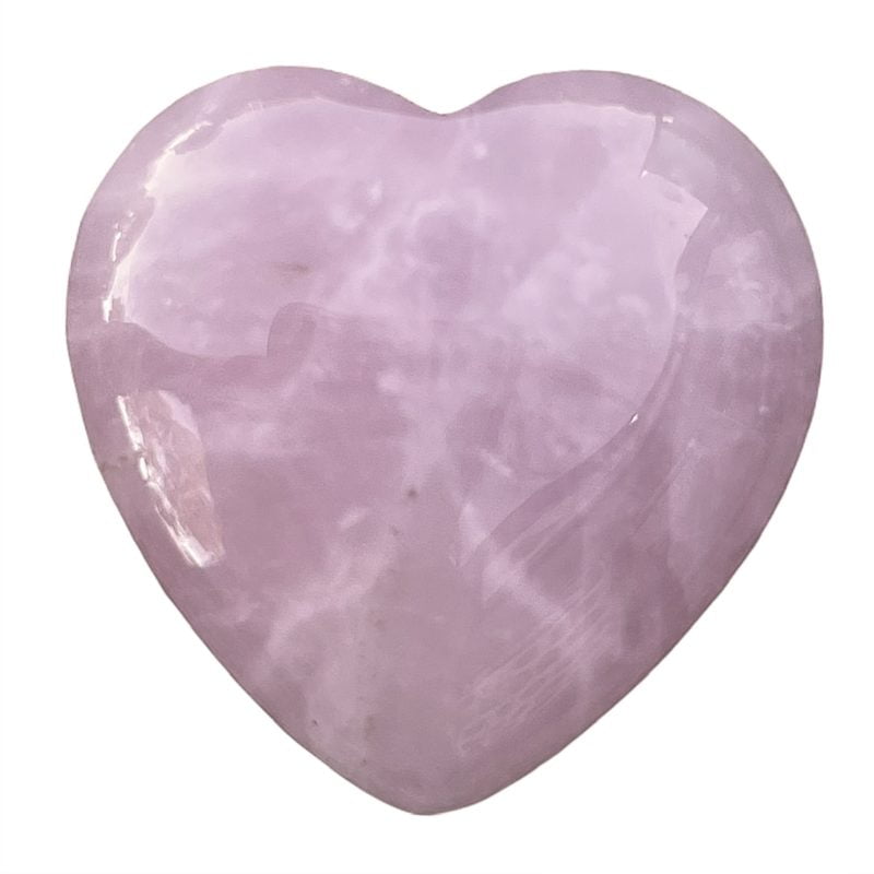 A heart shaped piece of pink quartz on a white background, alongside a Black Obsidian Heart.