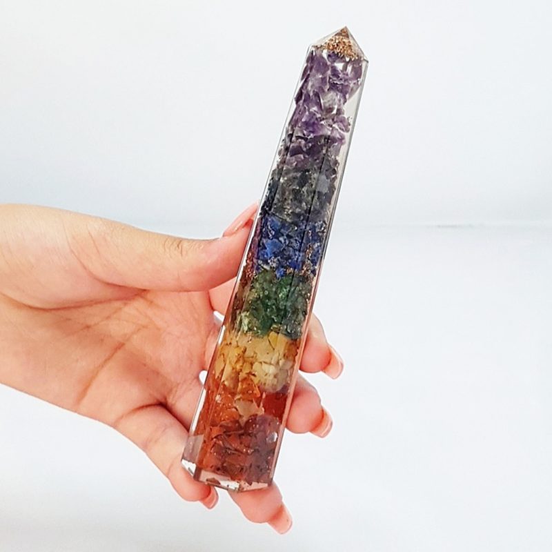 A person holding a rainbow crystal wand.