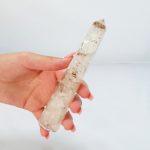 A person holding a piece of quartz in their hand.