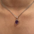 A stunning Amethyst Necklace gracing a woman's neck.