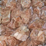 A pile of Orange Orchid Calcite Rough 60g AAA Grade.