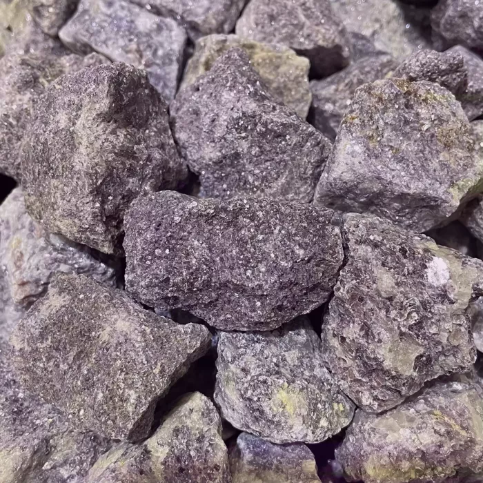 A pile of Lepidolite Rough 60g AAA Grade rocks on a table.