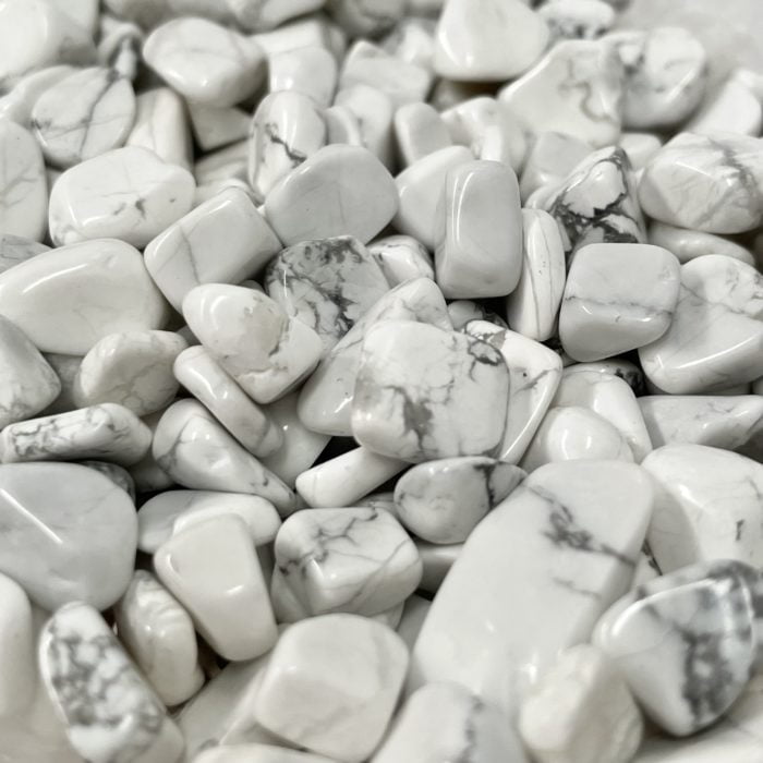 A pile of white Howlite Crystal Chips AAA Grade on a table.