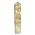 A yellow quartz point on a white background with a Caribbean Calcite Mini Tower.