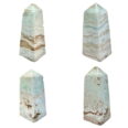 Four different pieces of aquamarine quartz and Caribbean Calcite Tower tower on a white background.