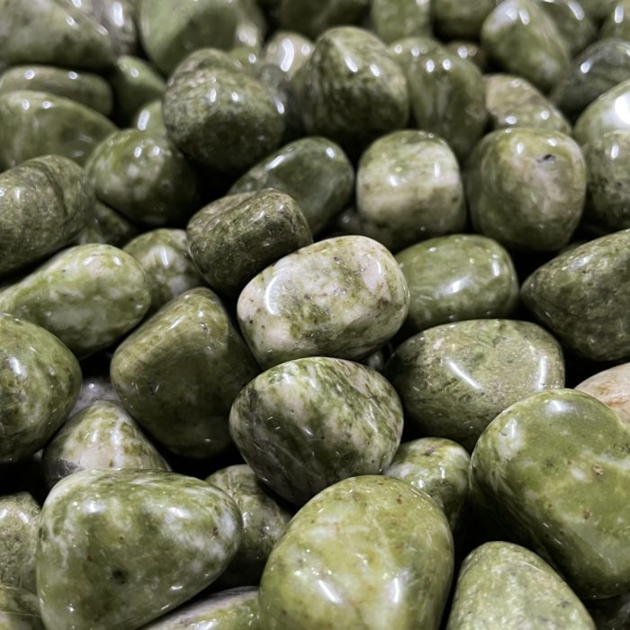 A pile of Epidot Quartz Tumbled pebbles.