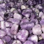 Lepidolite tumbled pebbles in a pile.