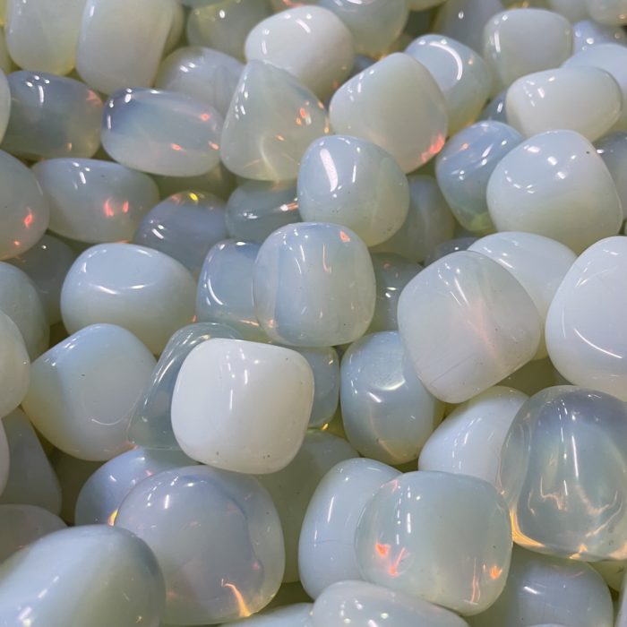 A pile of Opalite Tumbled on a table.