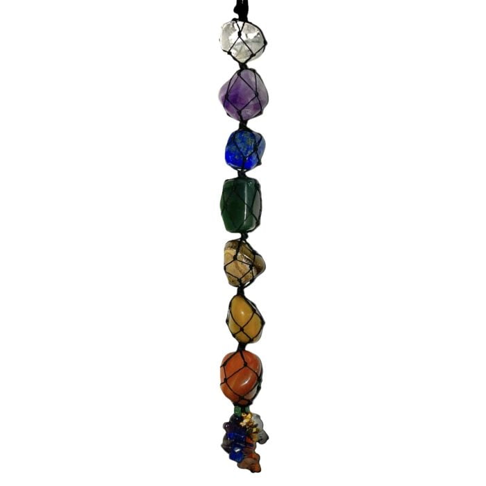 A Chakra Wall Hanging with a rainbow colored stone suspended from a string.