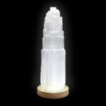 A white crystal tower on a wooden base.