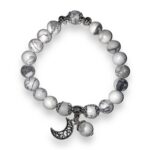 A white and silver bracelet with a moon charm.